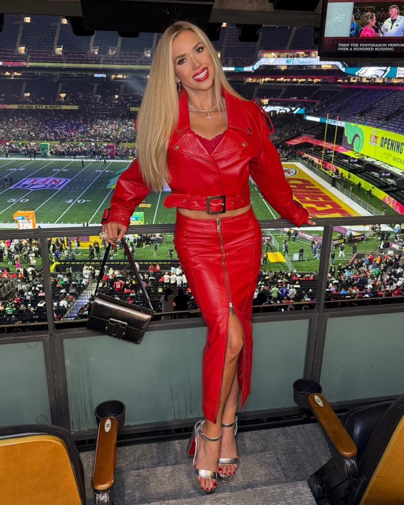 Gracie Hunt in a red leather outfit at Caesars Superdome, with the Kansas City Chiefs field visible below.