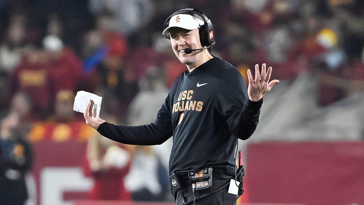 Head coach Lincoln Riley of the USC Trojans reacting on the sideline during a football game.