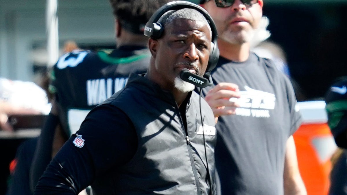 New York Jets head coach Aaron Glenn standing on the sidelines during a game.