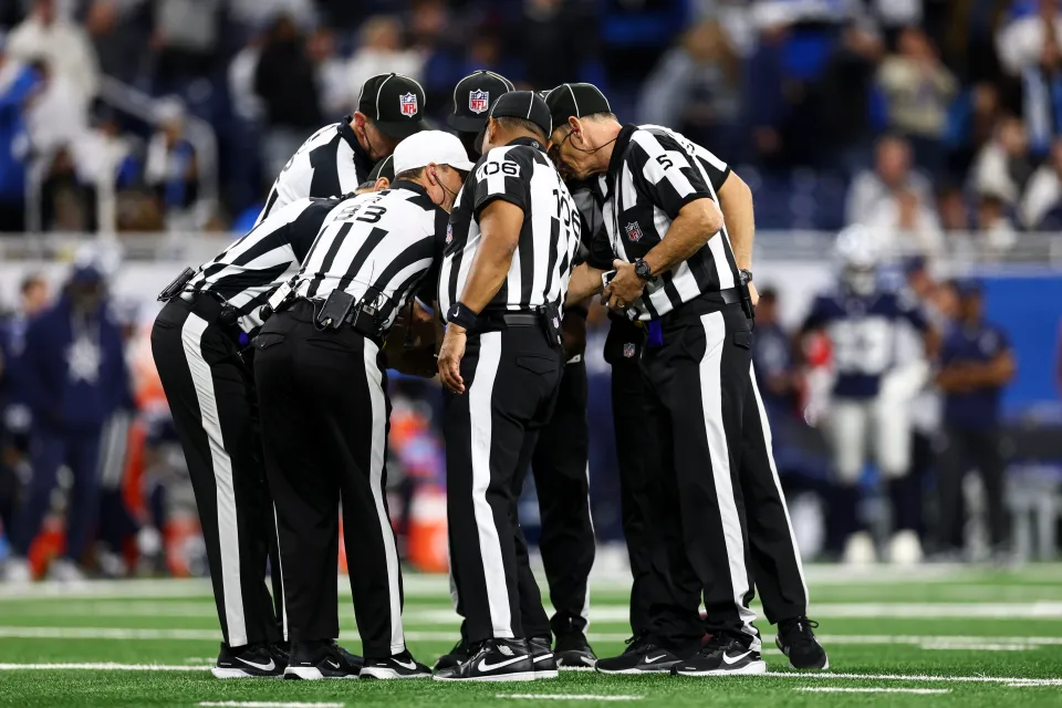 Referees huddle during the fourth quarter of an NFL football game between the Detroit Lions and the Dallas Cowboys at Ford Field on December 4, 2025