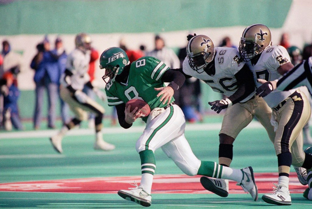 New York Jets quarterback Browning Nagle running from New Orleans Saints defenders Pat Swilling and Rickey Jackson.
