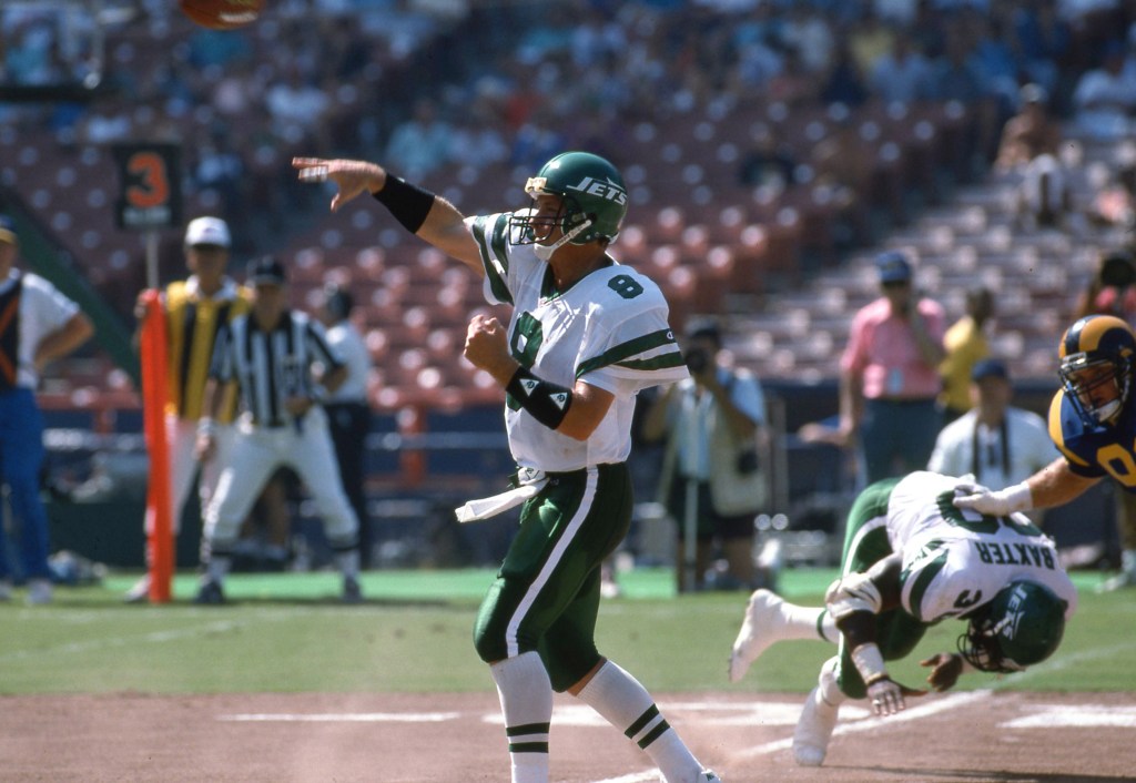 New York Jets quarterback Browning Nagle throwing a pass during an NFL game.