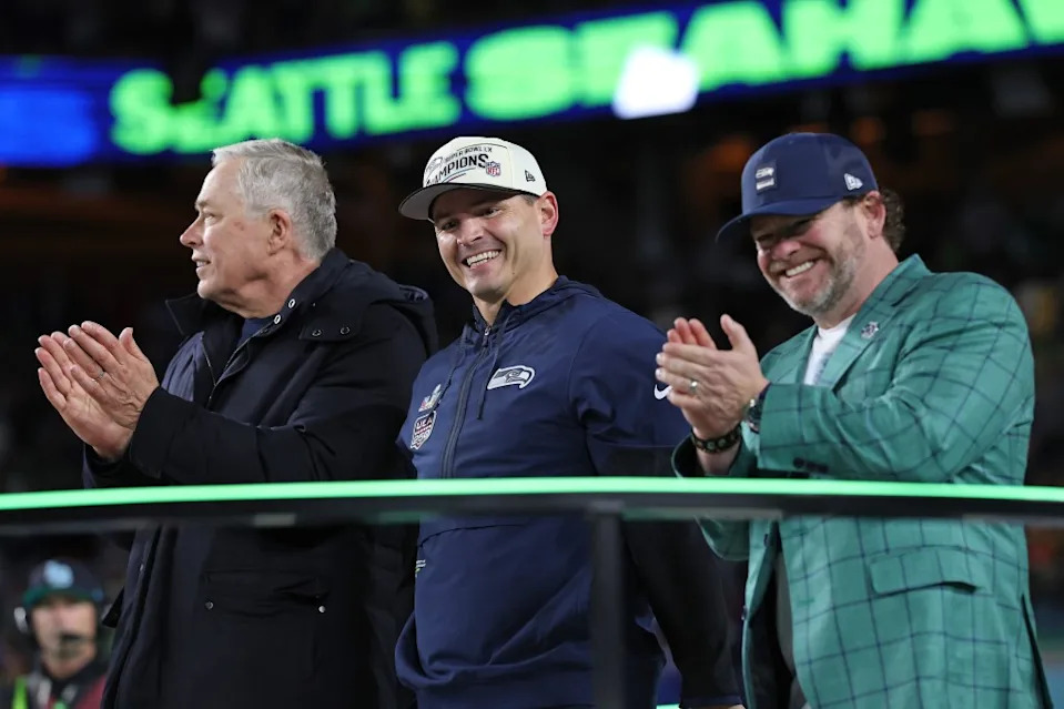 Seattle Seahawks head coach Mike MacDonald, center, and GM John Schneider, right