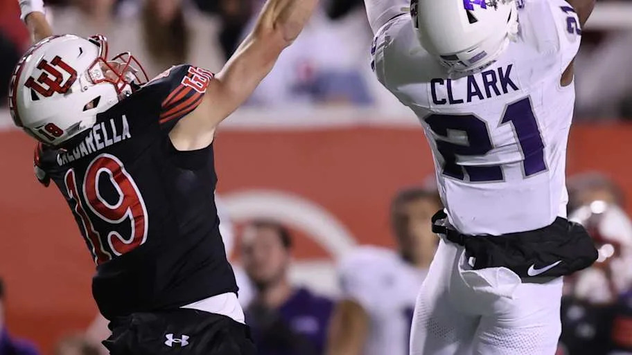 TCU Horned Frogs safety Bud Clark intercepts a pass intended for Utah Utes wide receiver Luca Caldarella.