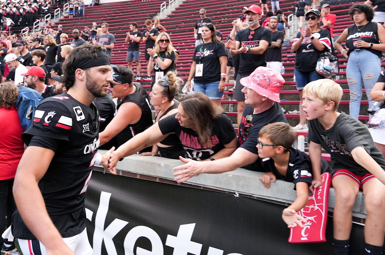 Cincinnati Bearcats quarterback Brendan Sorsby (2) high-fives fans after defeating the Northwestern State Demons 70-0, Saturday, Sept. 13, 2025, at Nippert Stadium in Cincinnati.