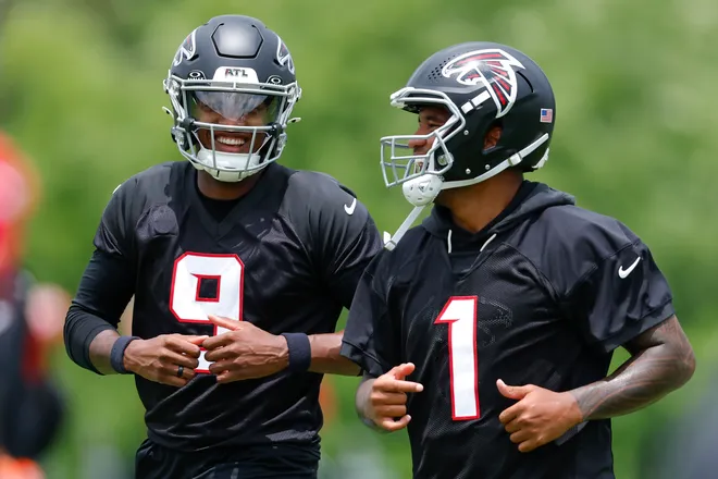 FLOWERY BRANCH, GEORGIA - MAY 27: Michael Penix Jr. #9 and Tua Tagovailoa #1 of the Atlanta Falcons laugh during OTA's at IBM Performance Field on May 27, 2026 in Flowery Branch, Georgia. (Photo by Todd Kirkland/Getty Images)