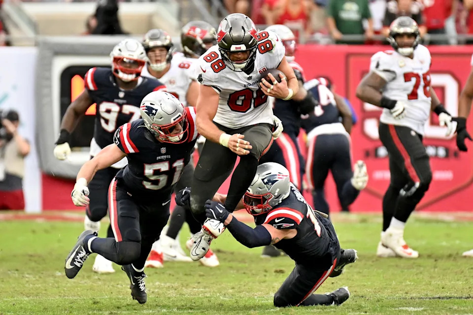 Nov 9, 2025; Tampa, Florida, USA; Tampa Bay Buccaneers tight end Cade Otton (88) runs for a gain past New England Patriots linebacker Jack Gibbens (51) during the fourth quarter at Raymond James Stadium. Mandatory Credit: Jonathan Dyer-Imagn Images