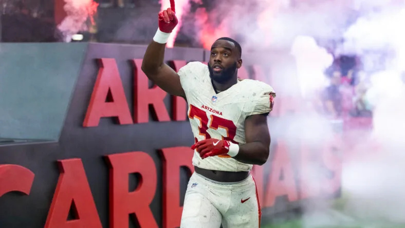 Trey Benson runs with the football during a Cardinals game against the Seattle Seahawks. Vikings trades