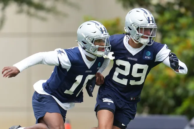 May 1, 2026; Frisco, TX, USA; Dallas Cowboys cornerback Devin Moore (29) and Dallas Cowboys safety Caleb Downs (18) go through a drill during practice at the Ford Center at the Star Training Facility in Frisco, Texas. Mandatory Credit: Chris Jones-Imagn Images