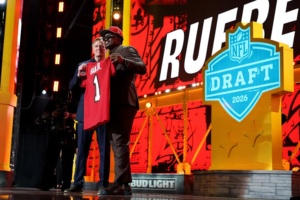 PITTSBURGH, PENNSYLVANIA - APRIL 23: Rueben Bain Jr. (R) of Miami poses with NFL Commissioner Roger Goodell (L) after being selected fifteenth overall pick by the Tampa Bay Buccaneers during Round One of the 2026 NFL Draft at Acrisure Stadium on April 23, 2026 in Pittsburgh, Pennsylvania. (Photo by Emilee Chinn/Getty Images)