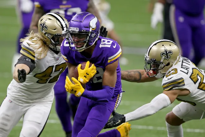 Dec 25, 2020; New Orleans, Louisiana, USA; Minnesota Vikings wide receiver Justin Jefferson (18) runs between New Orleans Saints middle linebacker Alex Anzalone (47) and cornerback Marshon Lattimore (23) in the second half at the Mercedes-Benz Superdome. Mandatory Credit: Chuck Cook-USA TODAY Sports