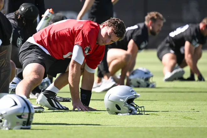 Las Vegas Raiders quarterback Fernando Mendoza (15) stretches during organized team activities at Intermountain Health Performance Center. Mandatory