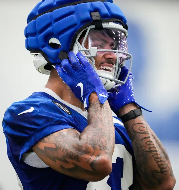 Indianapolis Colts wide receiver Eli Pancol (83) puts on his helmet Wednesday, May 27, 2026, during practice at the Indiana Farm Bureau Football Center in Indianapolis.
