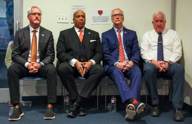 Bears leadership Brian McCaskey, from left, Kevin Warren, George McCaskey and Patrick McCaskey listen as head coach Ben Johnson speaks at Halas Hall on Jan. 21, 2026, in Lake Forest. (Stacey Wescott/Chicago Tribune)