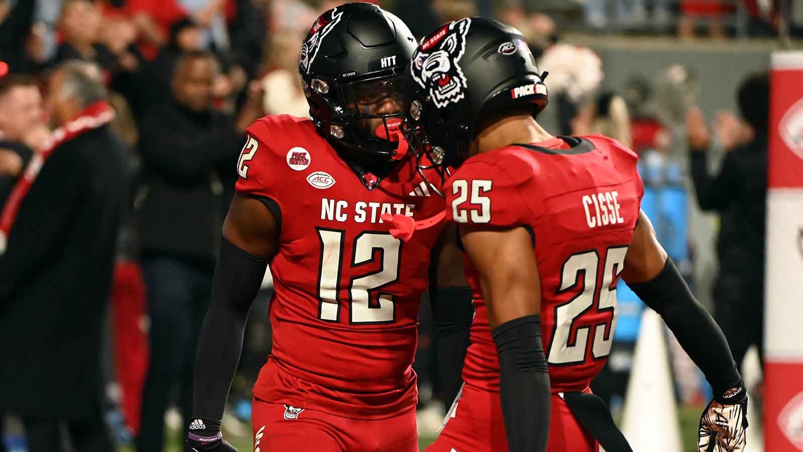 North Carolina State Wolfpack safety Devan Boykin (12) is greeted by teammate Brandon Cisse (25) after an interception