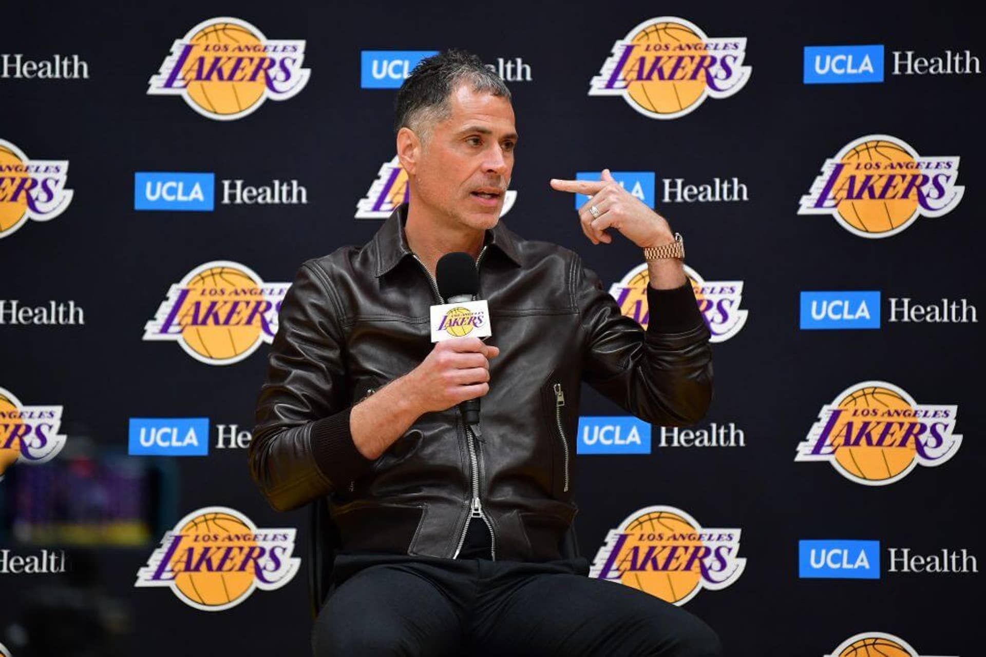 Lakers president Rob Pelinka speaks into a microphone during an event to welcome Luka Dončić to the team in 2025.