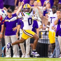 Sep 6, 2025; Baton Rouge, Louisiana, USA; LSU Tigers wide receiver Zavion Thomas (0) is tackled by Louisiana Tech Bulldogs defensive back Jacob Fields (8) during the first half against Louisiana Tech Bulldogs at Tiger Stadium.