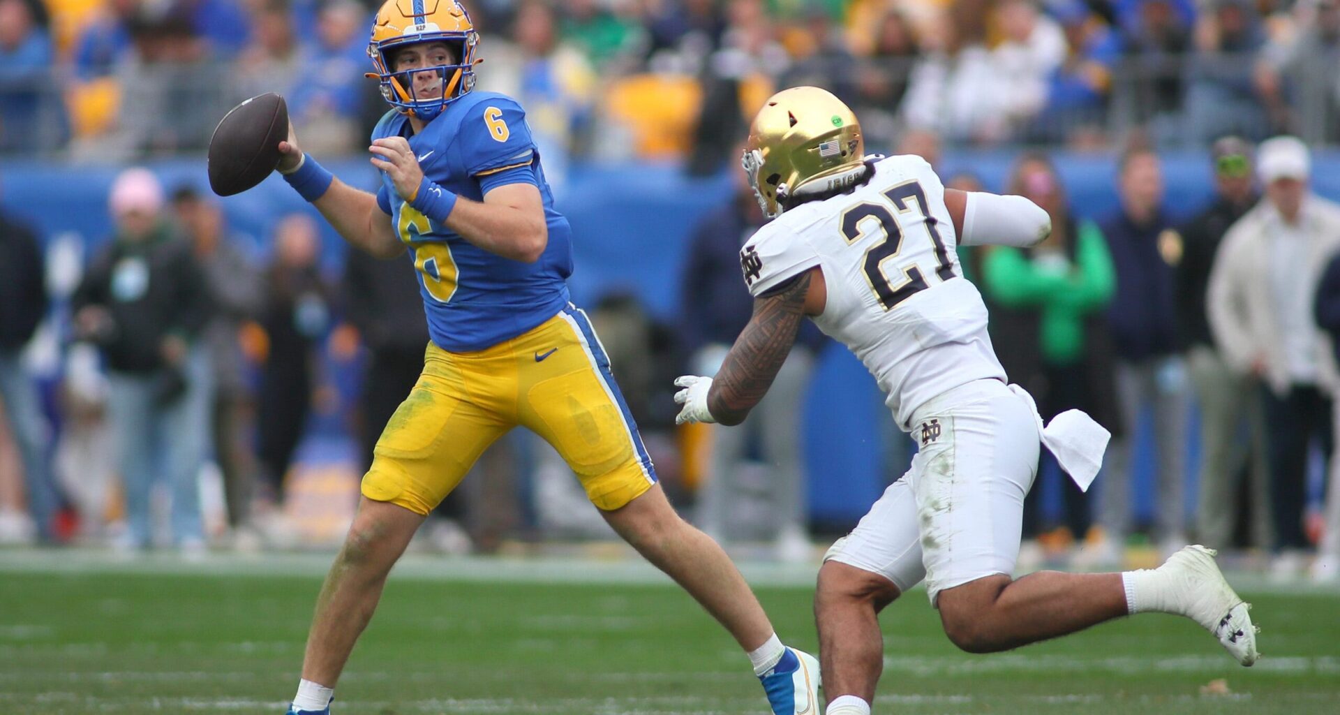 Pittsburgh Panthers quarterback Mason Heintschel (6) prepares to fire the ball downfield while being pressured by Notre Dame Fighting Irish linebacker Kyngstonn Viliamu-Asa (27) during the first half at Acrisure Stadium in Pittsburgh, PA on November 15, 2025.