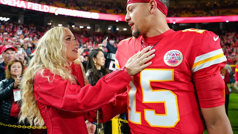 Oct 27, 2025; Kansas City, Missouri, USA; Kansas City Chiefs quarterback Patrick Mahomes (15) greets wife, Brittany Mahomes, during warmups prior to the game against the Washington Commanders at GEHA Field at Arrowhead Stadium. Mandatory Credit: Denny Medley-Imagn Images© Denny Medley-Imagn Images.
