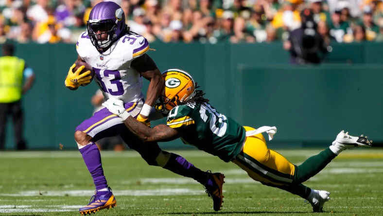Aaron Jones runs with the football against the Green Bay Packers at Lambeau Field. Vikings theories