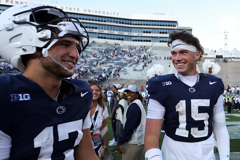 Aug 30, 2025; University Park, Pennsylvania, USA; Penn State Nittany Lions quarterbacks Ethan Grunkemeyer (17) and Drew Allar (15) share a moment together following the competition of the game against the Nevada Wolf Pack at Beaver Stadium. Penn State defeated Nevada 46-9. Mandatory Credit: Matthew O'Haren-Imagn Images