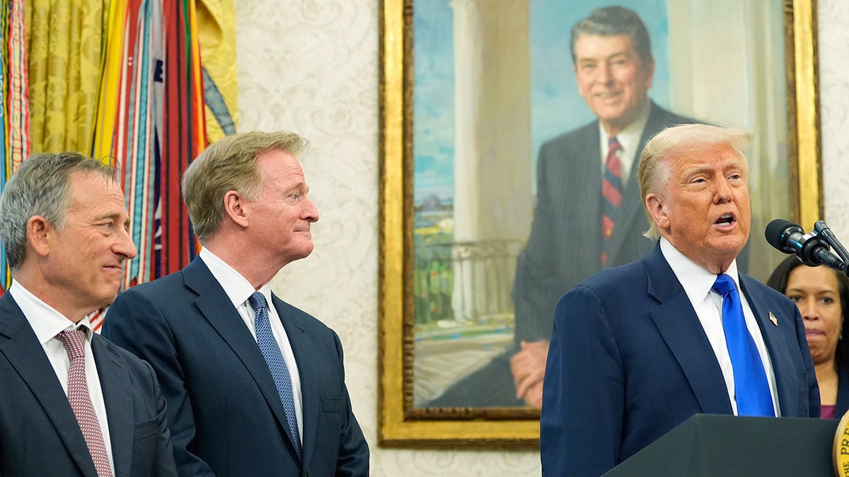 President Donald Trump speaking in the Oval Office with NFL Commissioner Roger Goodell, Josh Harris, and Mayor Muriel Bowser listening
