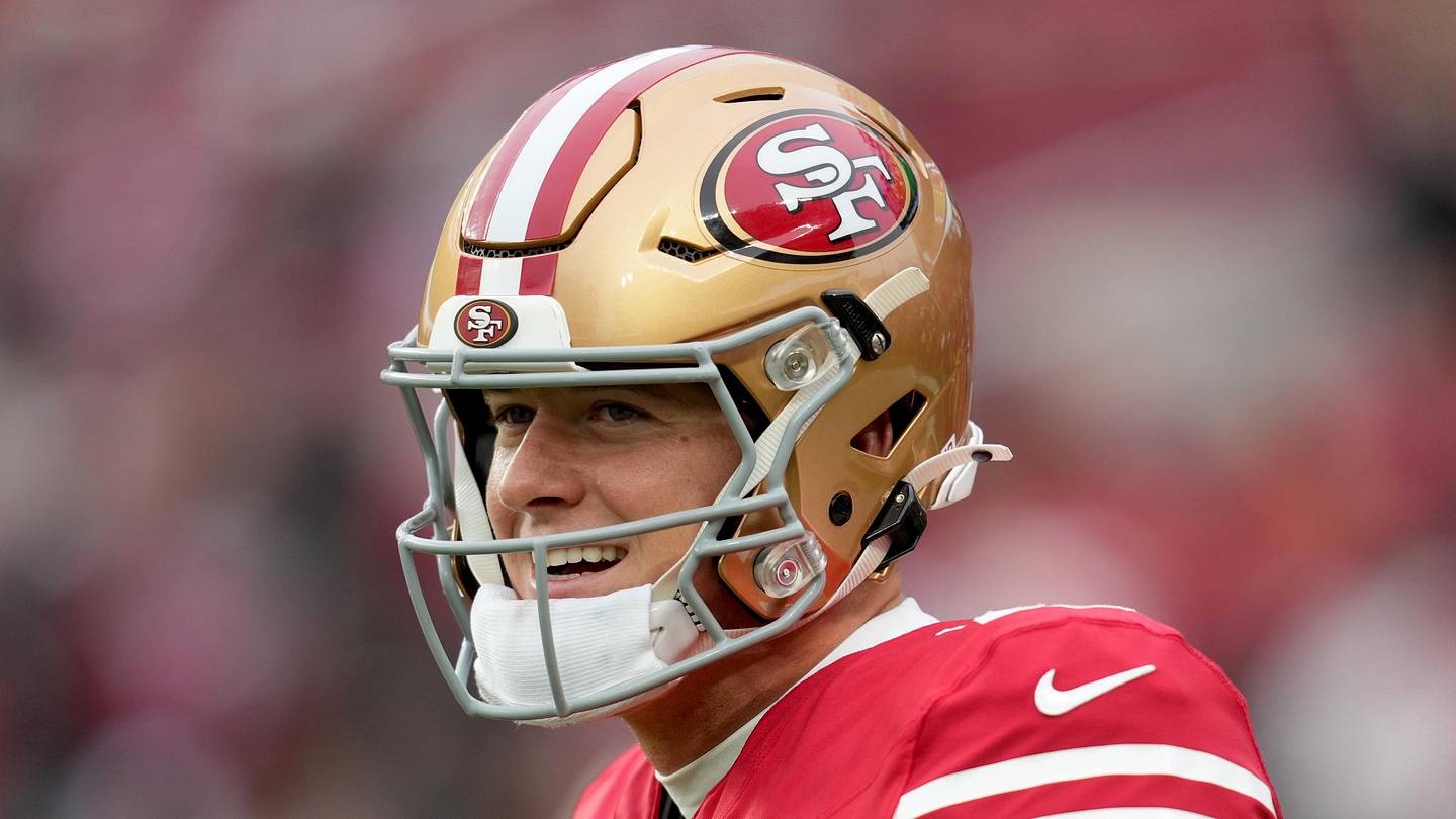 San Francisco 49ers quarterback Mac Jones warms up