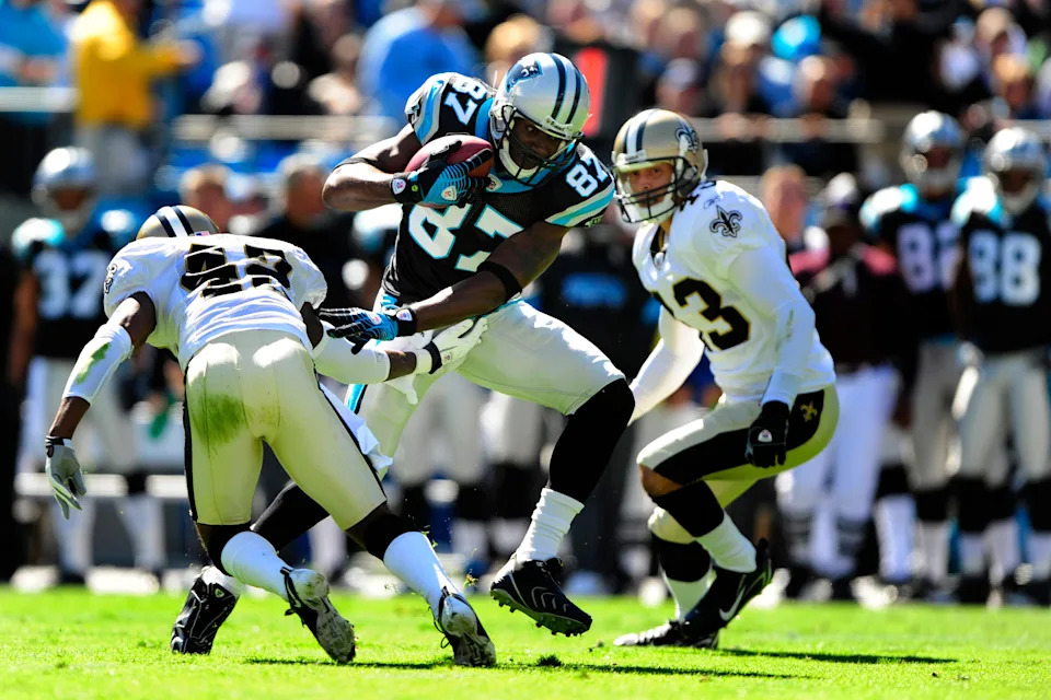 Oct 19, 2008; Charlotte, NC, USA; Carolina Panthers wide receiver Muhsin Muhammad (87) is tackled by New Orleans Saints cornerback Jason David (42) and safety Kevin Kaesviharn (43). The Panthers defeated the Saints 30-7 at Bank of America Stadium. Mandatory Credit: Bob Donnan-USA TODAY Sports