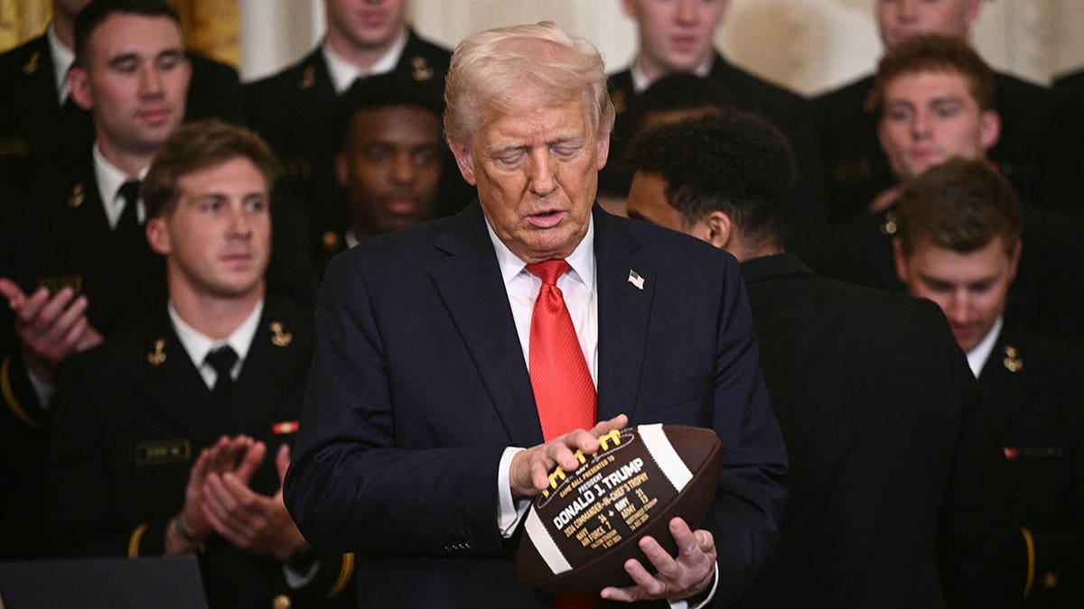 El presidente Donald con un balón de fútbol americano en la Sala Este de la Casa Blanca.