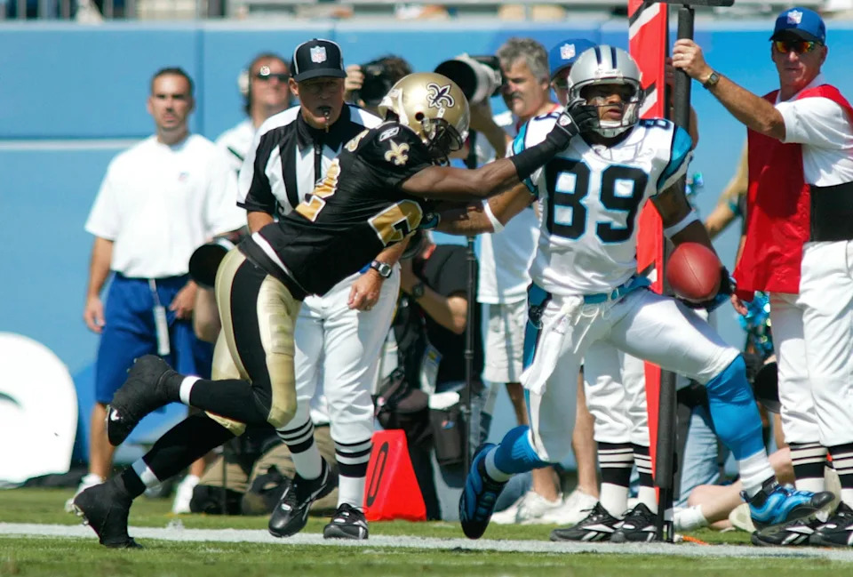 New Orleans Saints' cornerback Fred Thomas (L) grabs Carolina Panthers' wide receiver Steve Smith during first half action in their NFL football game in Charlotte, October 1, 2006. REUTERS/Chris Keane (UNITED STATES)