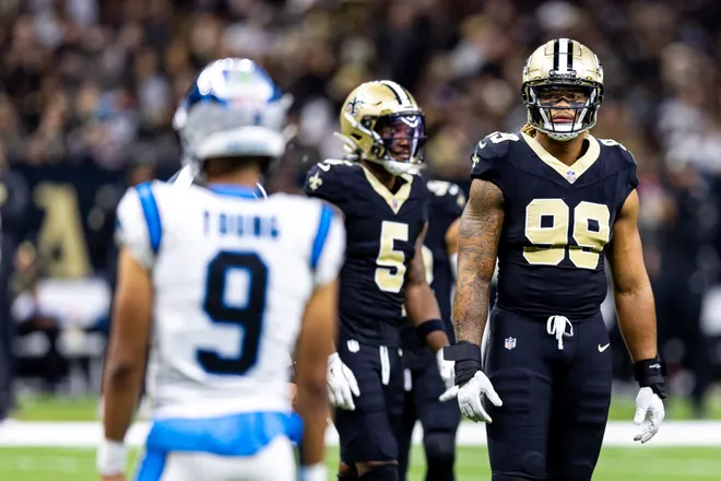 Sep 8, 2024; New Orleans, Louisiana, USA; Carolina Panthers defensive tackle Shy Tuttle (99) stares down Carolina Panthers quarterback Bryce Young (9) on a time out during the first half at Caesars Superdome. Mandatory Credit: Stephen Lew-Imagn Images