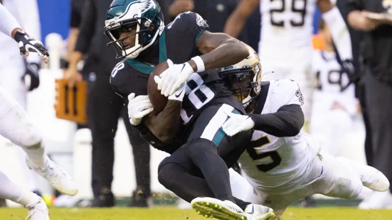 Jalen Reagor is tackled by Kwon Alexander after making a catch for the Eagles.