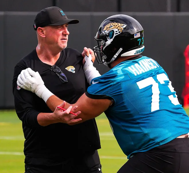Jaguars run game coordinator Brian Picucci runs a drill with center Robert Hainsey (73) during the Jaguarsâ€™ fourth OTA of the year, Monday June 1, 2026 at the Miller Electric Center in Jacksonville, Fla. [Doug Engle/Florida Times-Union]