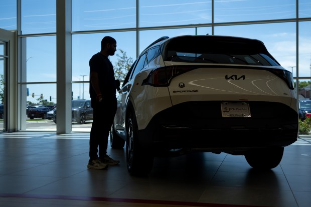 Kaival Patel, 28, of Schaumburg, checks out a 2026 Sportage PHEV X-Line AWD at Bob Rohrman Schaumburg Kia dealership on June 23, 2026. (Josh Boland/Chicago Tribune)