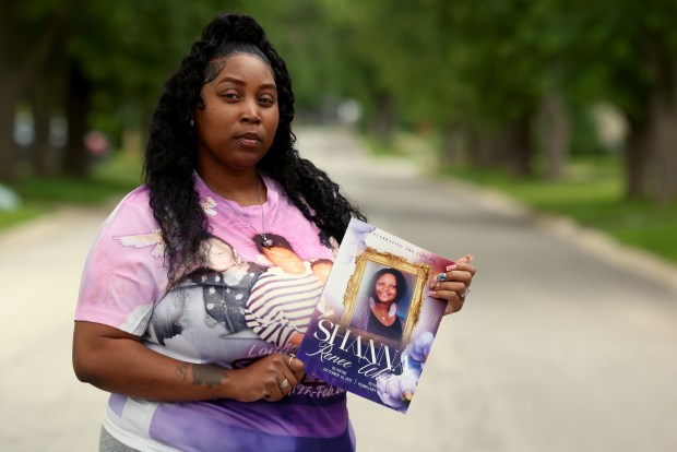 Shaeve White holds a photo of her mother, Shanna White, outside her home in Sauk Village on June 24, 2026. Shanna was killed in a hit-and run accident in Winthrop Harbor in February 2026. Shaeve White helped track down the suspect, Travis Kern, through social media. (Antonio Perez/Chicago Tribune)
