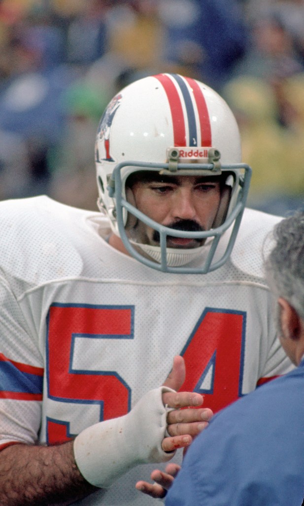 New England Patriots player Steve Nelson wearing a number 54 jersey and a white Riddell helmet.