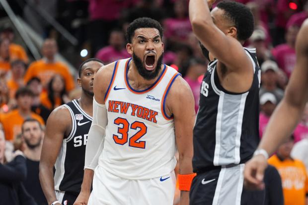 New York Knicks center Karl-Anthony Towns (32) yells during the second half of Game 1 of the NBA Finals basketball series against the San Antonio Spurs, Wednesday, June 3, 2026, in San Antonio. (AP Photo/Eric Gay)