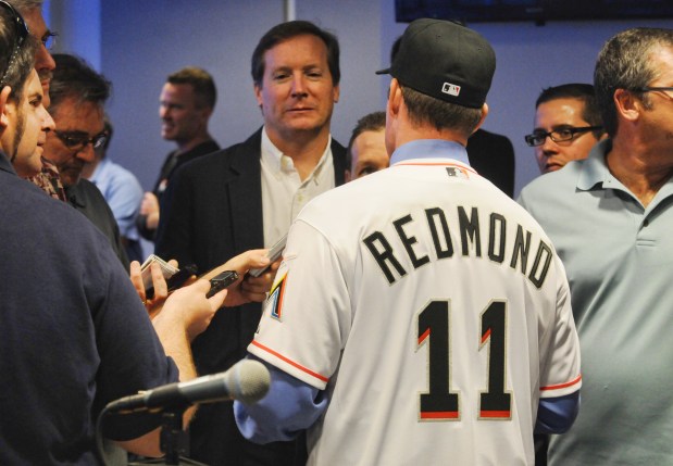 FILE Former Miami Marlins catcher Mike Redmond speaks with reporters, including South Florida Sun Sentinel columnist Dave Hyde, center, following a press conference at Marlins Park in Miami on Friday, Nov. 2, 2012. (Taimy Alvarez/South Florida Sun Sentinel)