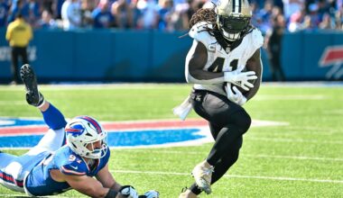 Sep 28, 2025; Orchard Park, New York, USA; New Orleans Saints running back Alvin Kamara (41) nearly fumbles after breaking a tackle by Buffalo Bills defensive end Joey Bosa (97) in the third quarter at Highmark Stadium.