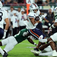 Nov 6, 2025; Tampa, Florida, USA; UTSA Roadrunners running back Will Henderson III (23) runs with the ball as South Florida Bulls cornerback Tavin Ward (2) tackles during the first half at Raymond James Stadium.
