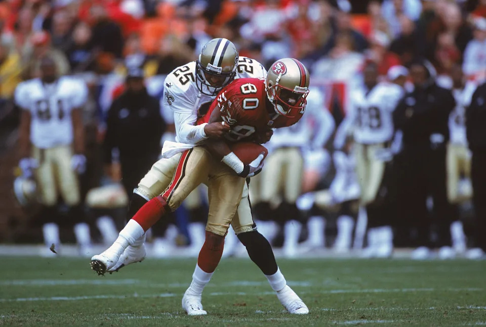 10 Dec 2000: Alex Molden #25 of the New Orleans Saints tries to tackle Jerry Rice #80 of the San Francisco 49ers during the game at 3Com Park in San Francisco, California. The Saints defeated the 49ers 31-27.Mandatory Credit: Tom Hauck /Allsport