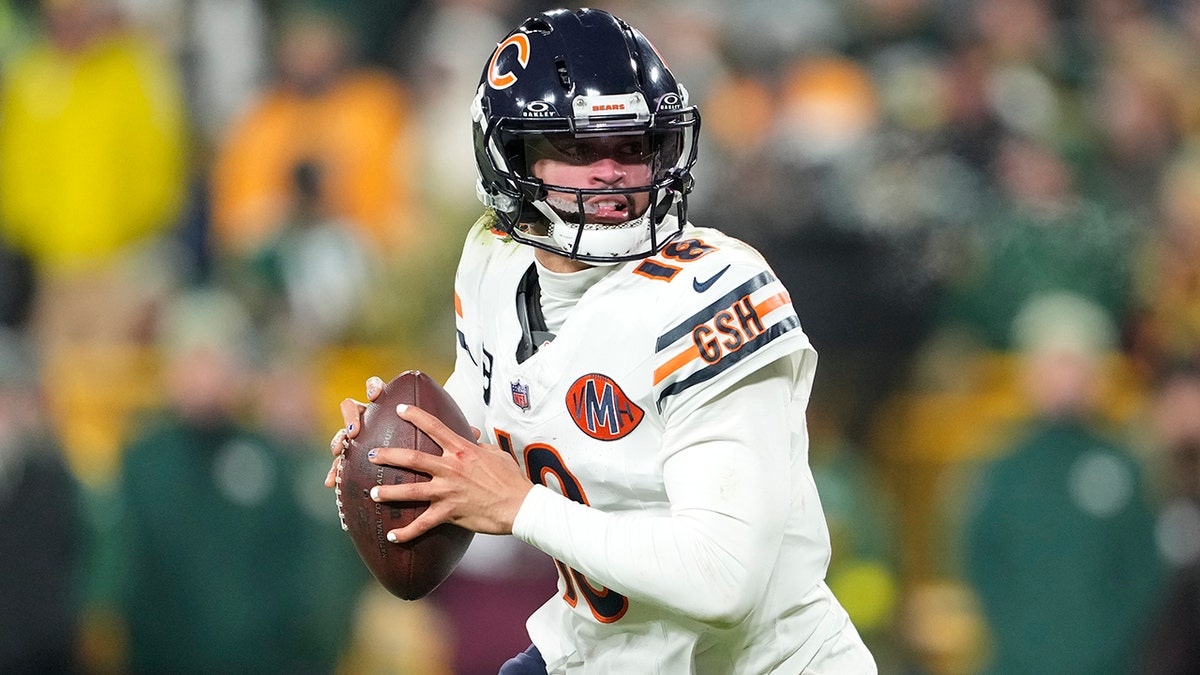Caleb Williams of the Chicago Bears looks to pass during a football game at Lambeau Field.