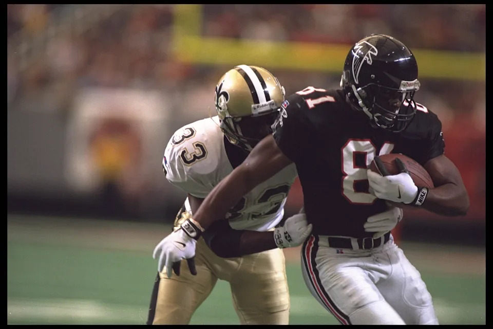 10 Dec 1995: Wide receiver Terance Mathis #81 of the Atlanta Falcons carries his reception downfield and is caught by centerback Tyrone Hughes #33 of the New Orleans Saints at the Georgia Dome in Atlanta, Georgia. The Falcons defeated the Saints 19-14.
