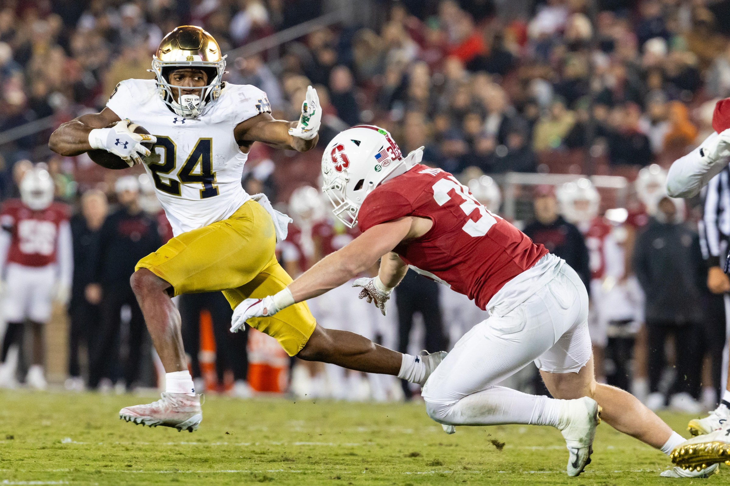 PALO ALTO, CA - NOVEMBER 29: Jadarian Price #24 of the Notre Dame Fighting Irish stiff arms Matt Rose #35 of the Stanford Cardinal during a game on November 29, 2025 at Stanford Stadium in Palo Alto, CA. (Photo by Matthew Huang/Icon Sportswire via Getty Images)