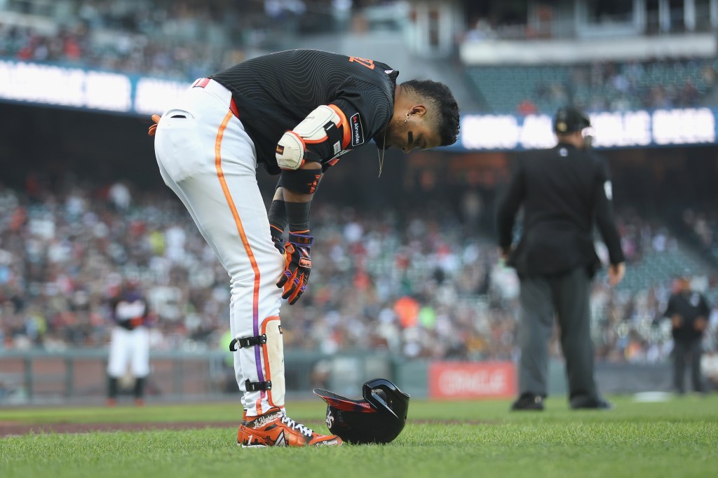 Luis Arraez of the San Francisco Giants reacting after hitting a foul ball into his leg.