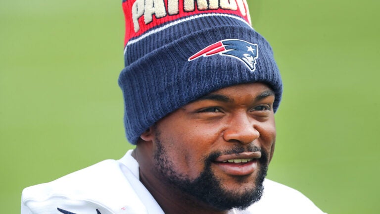 Patriots Keyshon Boutte wears a winter hat during stretching exercises as the New England Patriots held training camp at their facility at Gillette Stadium on Thursday.