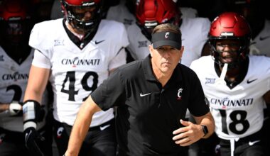 Cincinnati head coach Scott Satterfield, center, leads the team onto the field before an NCAA college football game against Central Florida, Oct. 12, 2024, in Orlando, Fla. (AP Photo/Phelan M. Ebenhack)