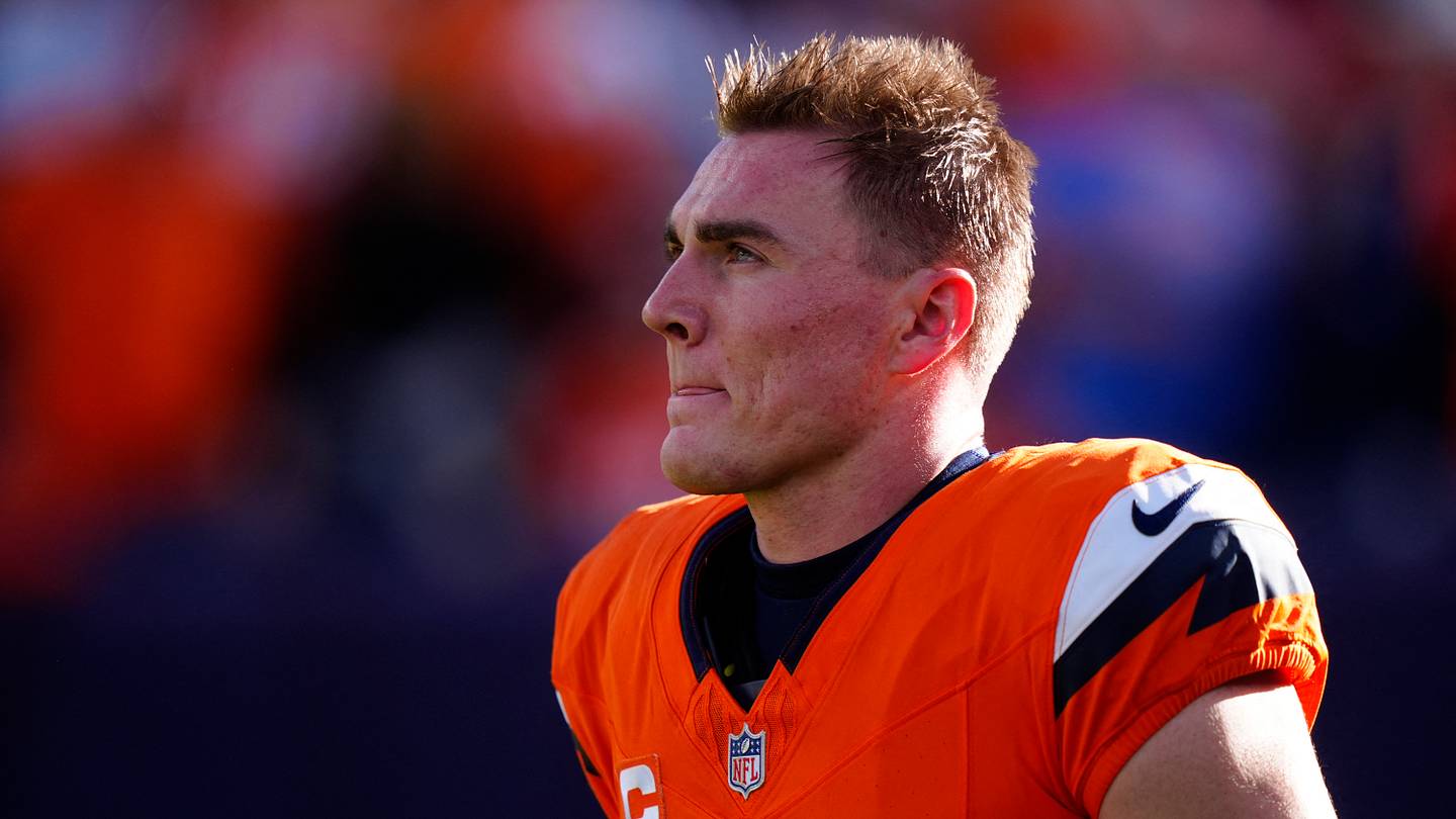 Denver Broncos quarterback Bo Nix warms up before a game against the Green Bay Packers.