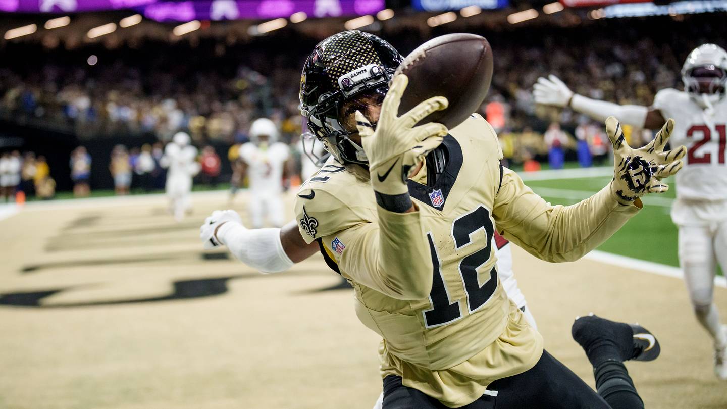 Sep 7, 2025; New Orleans, Louisiana, USA; New Orleans Saints wide receiver Chris Olave (12) tries to reel in a catch for a touchdown but dropped it against the Arizona Cardinals for the last play at Caesars Superdome. Mandatory Credit: Matthew Hinton-Imagn Images