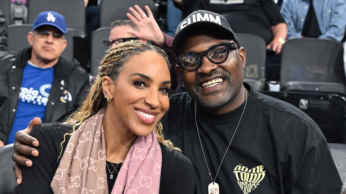Marcellus Wiley and wife, Annemarie, smile at game